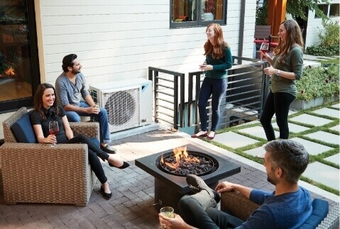 A group standing on the back deck near a Daikin Fit system